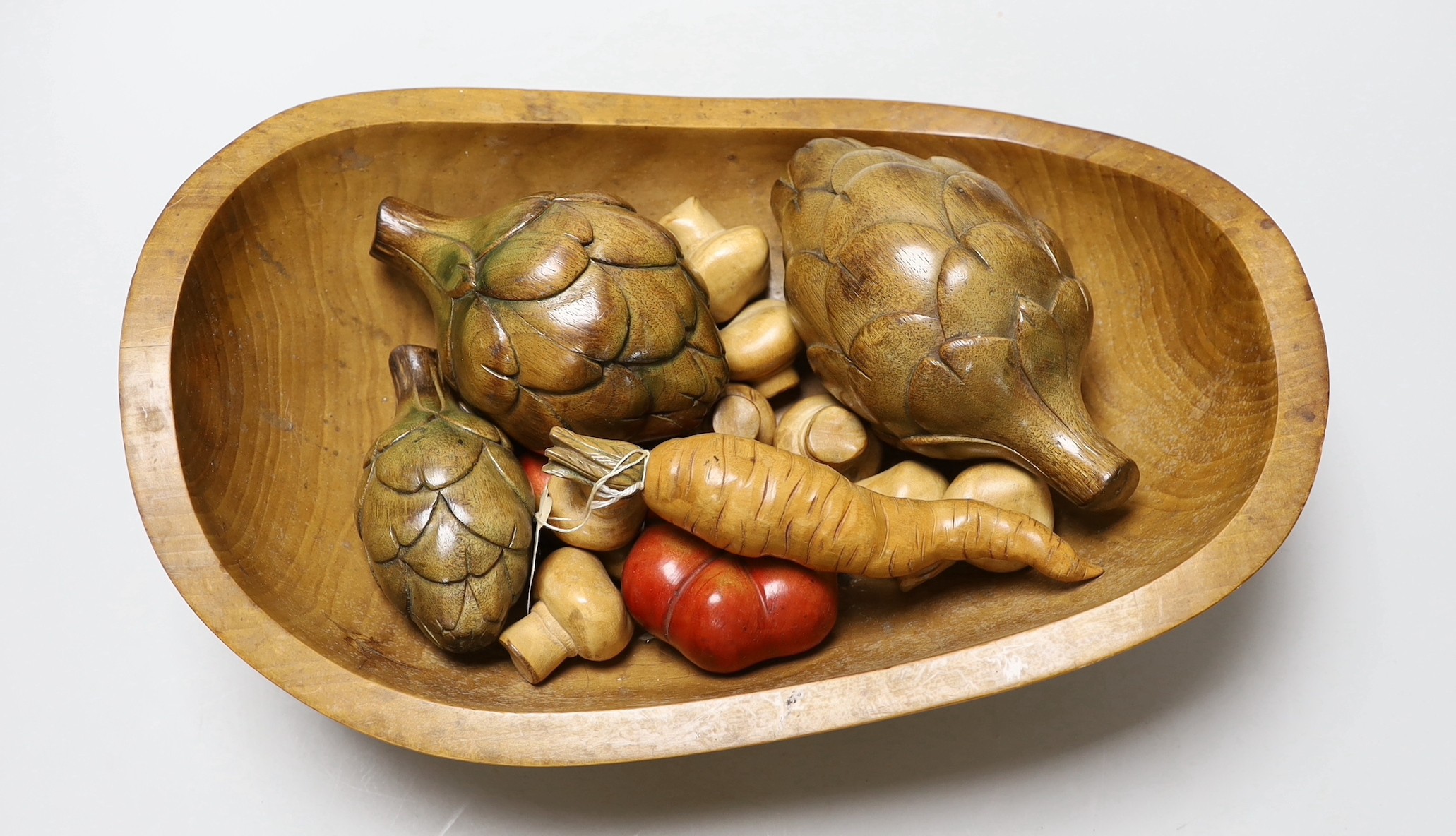 An Applewood bowl containing carved wooden fruit and vegetables, bowl 38cms wide